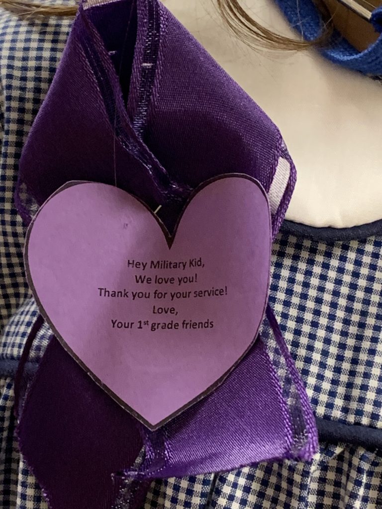 a close up of a purple heart and ribbon worn as a lapel to show support for military families